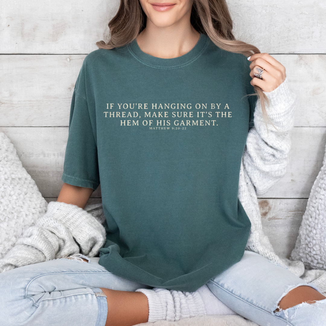 Hanging on By The Hem of His Garment Christian Graphic Tee: Blue Spruce / Small